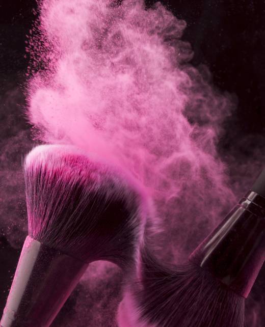 pink-powder-spread-with-brushes-rubbing-each-other